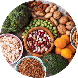 An array of magnesium-rich foods including leafy greens, whole grains, and nuts, representing foods that contain one of the ingredients used in Revvl Sleep for promoting restful sleep.